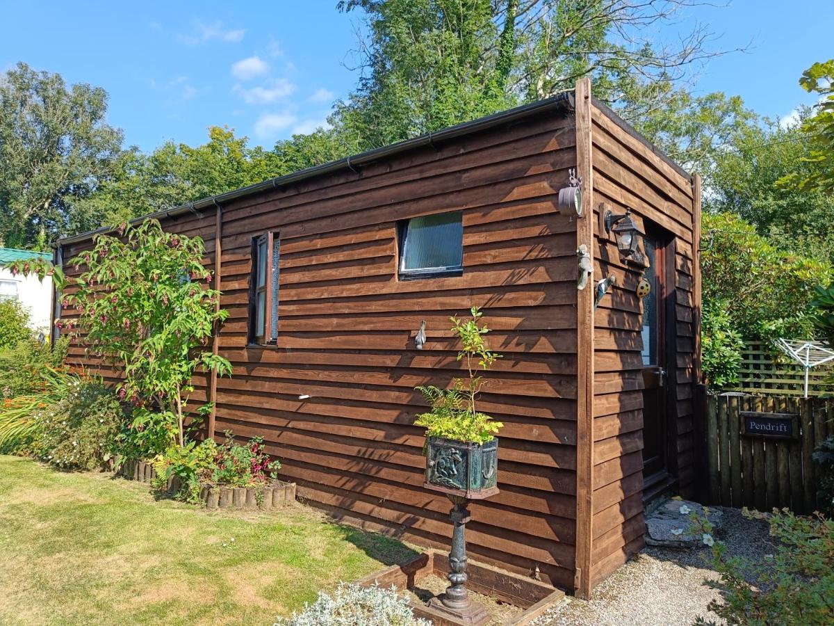 Wooden chalet with plants, grass and concrete pathway