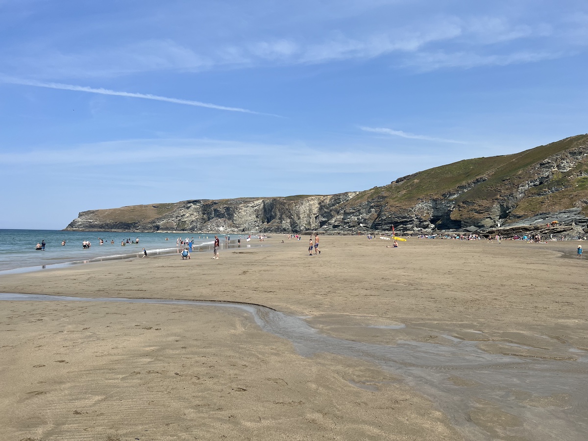 Sandy beach with cliffs in the background