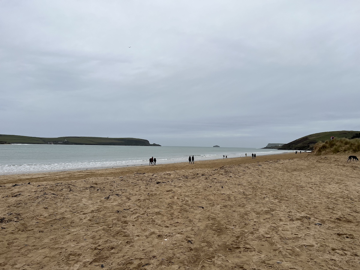 Sandy beach with grey cloudy sky